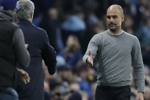Manchester City coach Pep Guardiola, right, shakes hands with Manchester United manager Jose Mourinho at the end of the English Premier League soccer match between Manchester City and Manchester United at the Etihad Stadium in Manchester, England, Saturday April 7, 2018. (AP Photo/Matt Dunham)