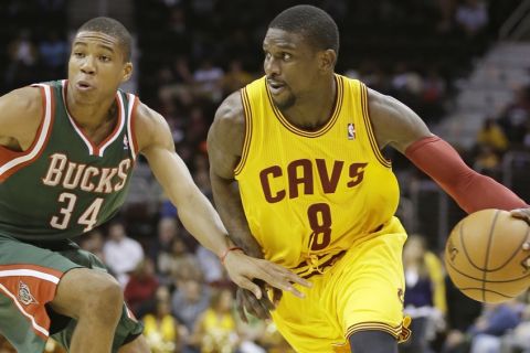 Cleveland Cavaliers' Jermaine Taylor (8) drives past Milwaukee Bucks' Giannis Antetokounmpo (34), from Greece, during an NBA preseason basketball game Tuesday, Oct. 8, 2013, in Cleveland. (AP Photo/Tony Dejak)