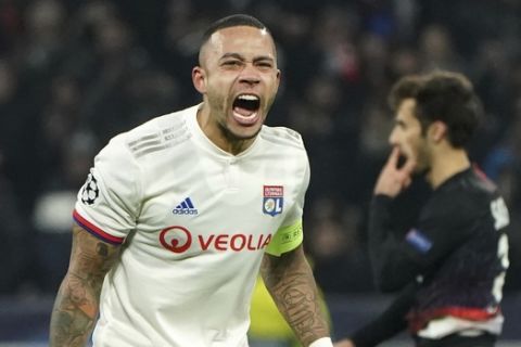 Lyon's Memphis Depay celebrates at the end of the match during the group G Champions League soccer match between Lyon and RB Leipzig at the Lyon Olympic Stadium in Decines, outside Lyon, France, Tuesday, Dec. 10, 2019. (AP Photo/Laurent Cipriani)