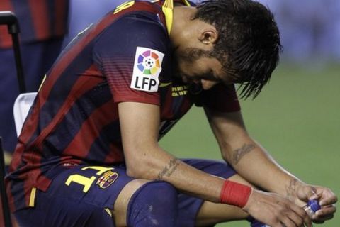 Barcelona's Neymar sits after Real Madrid won the final of the Copa del Rey between FC Barcelona and Real Madrid at the Mestalla stadium in Valencia, Spain, Wednesday, April 16, 2014. (AP Photo/Alberto Saiz) Spain Soccer Copa del Rey
