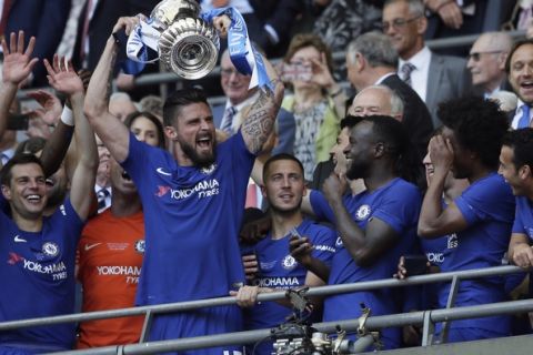 Chelsea's Olivier Giroud lifts the trophy after winning the English FA Cup final soccer match between Chelsea and Manchester United at Wembley stadium in London, Saturday, May 19, 2018. Chelsea defeated Manchester United 1-0. (AP Photo/Tim Ireland)