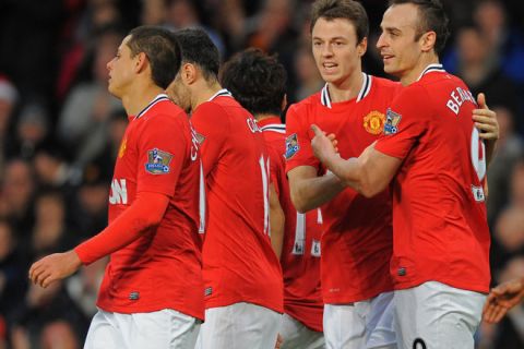 Manchester United's Bulgarian striker Dimitar Berbatov (R) celebrates with Northern Irish defender Jonny Evans (2nd R) after scoring their second goal during the English Premier League football match between Manchester United and Wigan Athletic at Old Trafford in Manchester, north-west England on December 26, 2011. AFP PHOTO/ANDREW YATES

RESTRICTED TO EDITORIAL USE. No use with unauthorized audio, video, data, fixture lists, club/league logos or live services. Online in-match use limited to 45 images, no video emulation. No use in betting, games or single club/league/player publications (Photo credit should read ANDREW YATES/AFP/Getty Images)