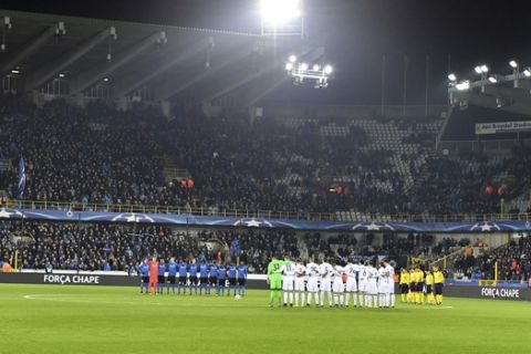 Players from Club Brugge and FC Copenhagen stand for a minute of silence during a Champions League Group G soccer match between Club Brugge and FC Copenhagen at the Jan Breydel stadium in Brugge, Belgium on Wednesday, Dec. 7, 2016. The moment of silence was held for victims of an airplane crash on Nov. 28, 2016 that killed 71 people, including most of the Brazilian football team, Chapecoense. (AP Photo/Geert Vanden Wijngaert)