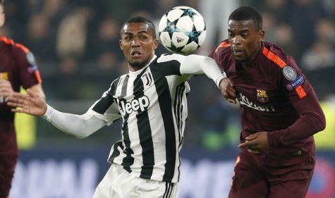 Juventus' Douglas Costa and Barcelona's Nelson Semedo vie for the ball during the Champions League group D soccer match between Juventus and Barcelona, at the Allianz Stadium in Turin, Italy, Wednesday, Nov. 22, 2017. (AP Photo/Antonio Calanni)