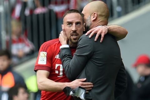 Franck Ribery of Munich celebrates his  open goal with  with coach Pep Guardiola, right, during the German Bundesliga soccer match between Bayern Munich and Eintracht Frankfurt in the Allianz Arena in Munich, Germany,Saturday, April 2, 2016. (Tobias Hase/dpa via AP)