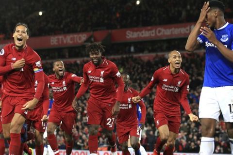 Liverpool forward Divock Origi, center, celebrates after scoring his side's first goal during the English Premier League soccer match between Liverpool and Everton at Anfield Stadium in Liverpool, England, Sunday, Dec. 2, 2018. (AP Photo/Jon Super)
