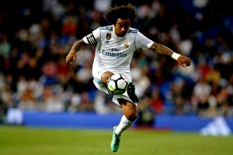 Real Madrid's Marcelo controls the ball during a Spanish La Liga soccer match between Real Madrid and Celta at the Santiago Bernabeu stadium in Madrid, Spain, Saturday, May 12, 2018. (AP Photo/Paul White)