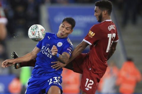 Leicester City's Leonardo Ulloa, left, and Liverpool's Joe Gomez battle for the ball during their English League Cup, third round soccer match at the King Power Stadium, Leicester, England, Tuesday, Sept. 19, 2017. (Mike Egerton/PA via AP)