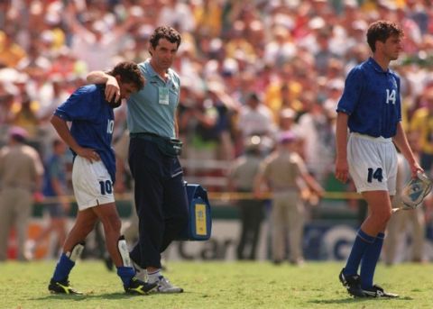 17 JUL 1994:  ROBERTO BAGGIO OF ITALY WALKS FROM THE FIELD WITH A TEAM OFFICIAL AFTER HE MISSED THE DECISIVE PENALTY IN THE PENALTY SHOOT-OUT ALLOWING BRAZIL TO WIN THE 1994 WORLD CUP FINAL AT THE ROSE BOWL IN PASADENA, CALIFORNIA.  AT RIGHT, IS NICOLA BERTI #14. Mandatory Credit: Ben Radford/ALLSPORT