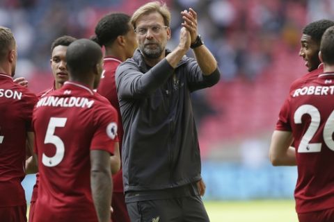 Liverpool's coach Jurgen Klopp center, applauds to fans and Liverpool's players after winning the English Premier League soccer match between Tottenham Hotspur and Liverpool at Wembley Stadium in London, Saturday Sept. 15, 2018. (AP Photo/Tim Ireland)
