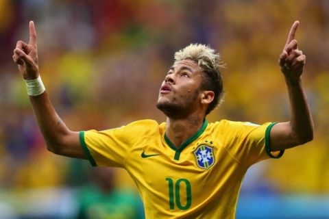 BRASILIA, BRAZIL - JUNE 23:  Neymar of Brazil celebrates scoring his team's second goal and his second of the game during the 2014 FIFA World Cup Brazil Group A match between Cameroon and Brazil at Estadio Nacional on June 23, 2014 in Brasilia, Brazil.  (Photo by Clive Brunskill/Getty Images)