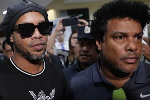 Former Brazilian soccer star Ronaldinho, whose full name is Ronaldo de Assis Moreira, center, and his brother Roberto, right, leave the attorney generals office after making a statement in Asuncion, Paraguay, Thursday, March 5, 2020. Ronaldinho and his brother were detained by Paraguayan police for allegedly entering the country with falsified passports on Wednesday. (AP Photo/Jorge Saenz)
