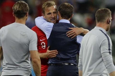 England's Harry Kane is embraced by coach Gareth Southgate after the group G match between Tunisia and England at the 2018 soccer World Cup in the Volgograd Arena in Volgograd, Russia, Monday, June 18, 2018. England won 2-1 and Kane scored the winning goal. (AP Photo/Alastair Grant)