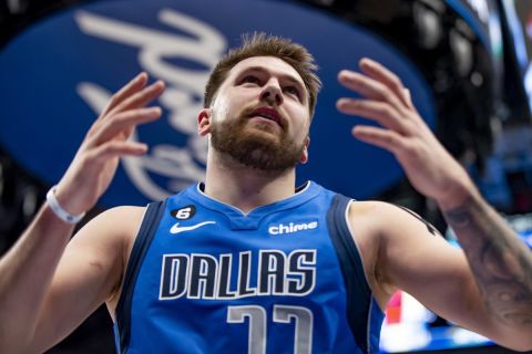 Dallas Mavericks guard Luka Doncic (77) throws his hands up after drawing a foul on a made basket in the first half of an NBA game against the Cleveland Cavaliers in Dallas, Texas, Wednesday, Dec. 14, 2022. (AP Photo/Emil Lippe)
