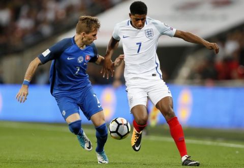 England's Marcus Rashford and Slovakia's Peter Pekarik, from right, challenge for the ball during the World Cup Group F qualifying soccer match between England and Slovakia at Wembley Stadium in London, England, Monday, Sept. 4, 2017. (AP Photo/Kirsty Wigglesworth)
