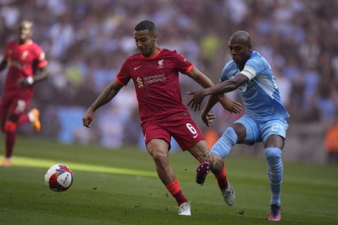 Liverpool's Thiago, left, fights for the ball with Manchester City's Fernandinho during the English FA Cup semifinal soccer match between Manchester City and Liverpool at Wembley stadium in London, Saturday, April 16, 2022. (AP Photo/Frank Augstein)
