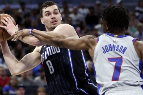 Orlando Magic's Mario Hezonja (8) looks to pass the ball over Detroit Pistons' Stanley Johnson (7) during the second half of an NBA basketball game, Friday, March 2, 2018, in Orlando, Fla. Orlando won 115-106 in overtime.(AP Photo/John Raoux)