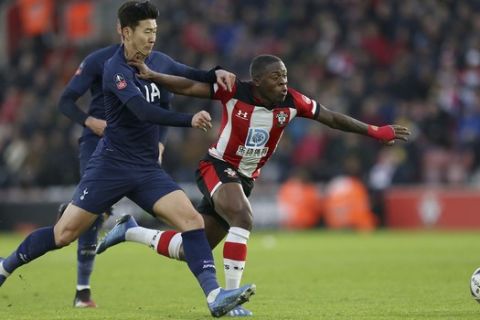 Tottenham Hotspur's Son Heung-min, left, and Southampton's Michael Obafemi battle for the ball during the FA Cup fourth round soccer match between Southampton and Tottenham Hotspur at St Mary's Stadium, Southampton, England. Saturday, Jan. 25, 2020. (Steven Paston/PA via AP)