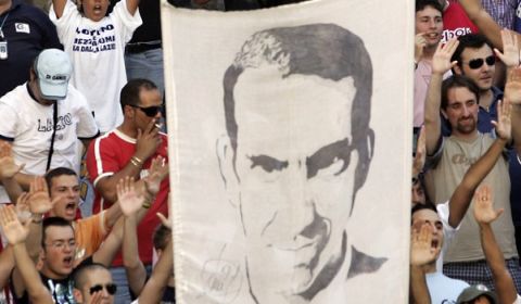 Lazio soccer team supporters hold up an image depicting the team's former captain Paolo Di Canio gather at Rome's capitol hill Friday, July 21, 2006. A sports tribunal recently demoted Juventus soccer club to Serie B for match-fixing and stripped it of its last two Serie A titles. Lazio and Fiorentina also were demoted to the second division. AC Milan was spared demotion but was given a 15-point penalty in the top division. Di Canio recently signed to play for a fourth-division team, Cisco Roma, the capital's third team after Lazio and AS Roma. (AP Photo/Gregorio Borgia)