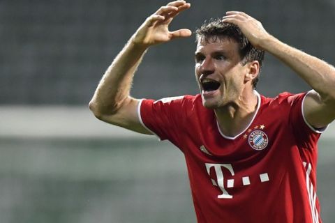 Bayern's Thomas Mueller reacts after a missed scoring opportunity during the German Bundesliga soccer match between Werder Bremen and Bayern Munich in Bremen, Germany, Tuesday, June 16, 2020. Because of the coronavirus outbreak all soccer matches of the German Bundesliga take place without spectators. (AP Photo/Martin Meissner, Pool)