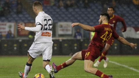 Roma's Kostas Manolas and Genoa's Darko Lazovic, left, vie for the ball during an Italian Serie A soccer match between Roma and Genoa, at the Olympic stadium in Rome, Sunday, Dec. 16, 2018. (AP Photo/Gregorio Borgia)