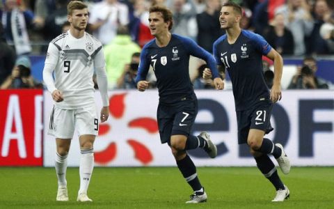 France's Antoine Griezmann, enter, celebrates with France's Lucas Hernandez while Germany's Timo Werner, left, looks on after scoring France's opening goal during their UEFA Nations League soccer match between France and Germany at Stade de France stadium in Saint Denis, north of Paris, Tuesday, Oct. 16, 2018. (AP Photo/Francois Mori)