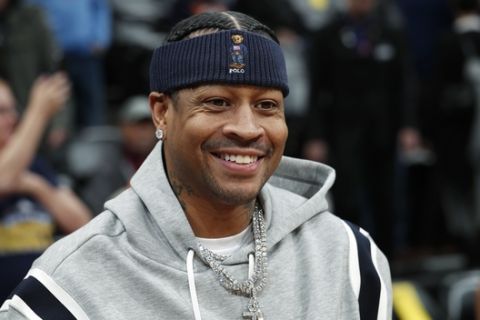 Retired Denver Nuggets guard Allen Iverson smiles as he jokes with fans before taking a seat to watch the Nuggets play the San Antonio Spurs in an NBA basketball game Friday, Feb. 23, 2018, in Denver. Iverson joined former teammates Kenyon Martin and Marcus Camby to be honored by the team during a ceremony at halftime. (AP Photo/David Zalubowski)