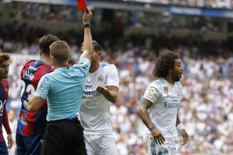 Real Madrid's Marcelo, right, is shown a red card by referee Hernandez Hernandez during the Spanish La Liga soccer match between Real Madrid and Levante at the Santiago Bernabeu stadium in Madrid, Saturday, Sept. 9, 2017. The match ended in a 1-1 draw. (AP Photo/Francisco Seco)