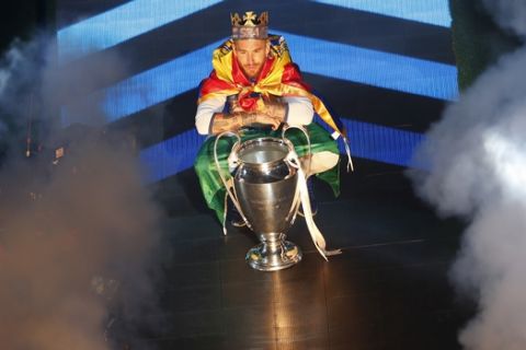 Real Madrid captain Sergio Ramos poses for a photograph with the Champions League trophy as he celebrates with the rest of the team after winning the Champions League final, at the Santiago Bernabeu stadium in Madrid, Spain, Sunday, June 4, 2017. Real Madrid became the first team in the Champions League era to win back-to-back titles with their 4-1 victory over Juventus in Cardiff, Wales, on Saturday. (AP Photo/Francisco Seco)