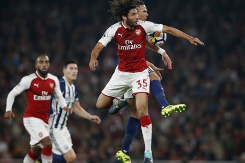 Arsenal's Mohamed Elnenar, vies for the ball with West Bromwich Albion's Kieran Gibbs, right,during their English Premier League soccer match between Arsenal and West Bromwich Albion at the Emirates stadium in London, Monday, Sept. 25, 2017. (AP Photo/Alastair Grant)