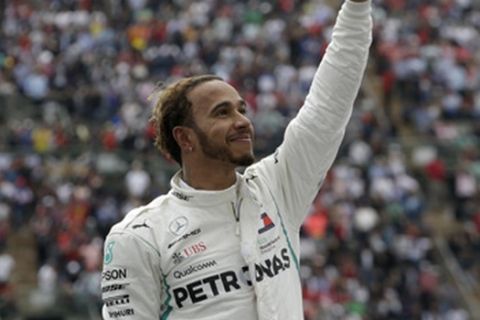 Mercedes driver Lewis Hamilton, of Britain, celebrates becoming Formula One champion during the Mexico Grand Prix auto race at the Hermanos Rodriguez racetrack in Mexico City, Sunday, Oct. 28, 2018. (AP Photo/Moises Castillo)