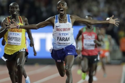 Britain's Mo Farah crosses the line to win the gold medal in the Men's 10,000m final during the World Athletics Championships in London Friday, Aug. 4, 2017. (AP Photo/David J. Phillip)
