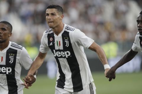 Juventus' Cristiano Ronaldo, centre, celebrates with teammates Juventus' Douglas Costa, left and Juventus' Blaise Matuidi after the end of the Serie A soccer match between Juventus and Lazio at the Allianz Stadium in Turin, Italy, Saturday, Aug. 25, 2018. Juventus won the game 2-0.(AP Photo/Luca Bruno)