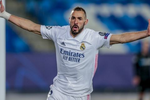 Real Madrid's Karim Benzema celebrates after scoring his side's second goal during the Champions League group B soccer match between Real Madrid and Borussia Monchengladbach at the Alfredo Di Stefano stadium in Madrid, Spain, Wednesday, Dec. 9, 2020. (AP Photo/Bernat Armangue)