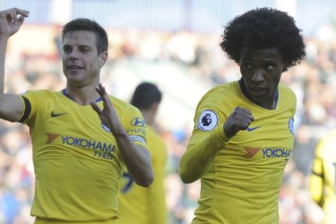 Chelsea's Willian, right, celebrates after scoring his side 3rd goal od the game during the English Premier League soccer match between Burnley and Chelsea at Turf Moor stadium in Burnley, England, Sunday, Oct. 28, 2018. (AP Photo/Rui Vieira)