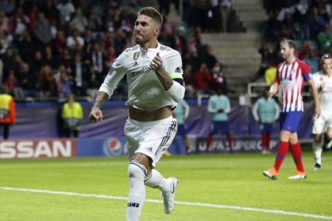 Real Madrid's Sergio Ramos runs to celebrate after scoring his sides second goal during the UEFA Super Cup final soccer match between Real Madrid and Atletico Madrid at the Lillekula Stadium in Tallinn, Estonia, Wednesday, Aug. 15, 2018. (AP Photo/Pavel Golovkin)