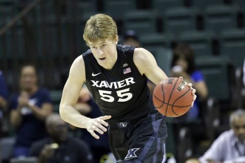 Xavier's J.P. Macura (55) moves the ball against Missouri during the first half of the Tire Pros Invitational NCAA college basketball tournament, Thursday, Nov. 17, 2016, in Kissimmee, Fla. (AP Photo/John Raoux)