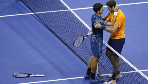 Novak Djokovic, of Serbia, left, hugs Juan Martin del Potro, of Argentina, after Djokovic defeated del Potro in the men's final of the U.S. Open tennis tournament, Sunday, Sept. 9, 2018, in New York. (AP Photo/Jason DeCrow)