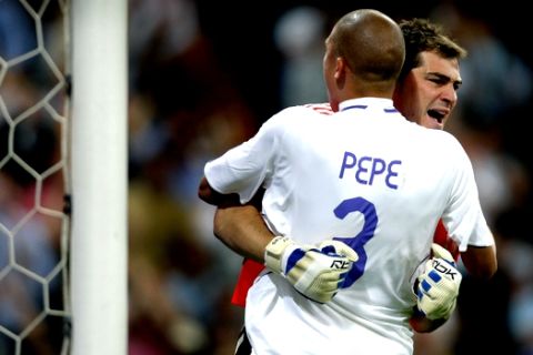 Real Madrid goalkeeper Iker Casillas, right, celebrates with teammate Pepe, left, after he saved a penalty during their Spanish League soccer match against Athletic Bilbao at the Santiago Bernabeu stadium in Madrid, Spain, Sunday, April, 27, 2008. (AP Photo/Fernando Bustamante)