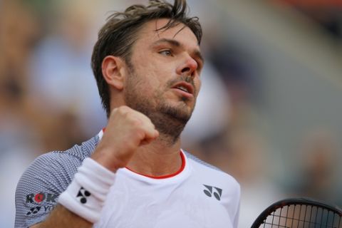 Switzerland's Stan Wawrinka clenches his fist after scoring a point against Switzerland's Roger Federer during their quarterfinal match of the French Open tennis tournament at the Roland Garros stadium in Paris, Tuesday, June 4, 2019. (AP Photo/Michel Euler)