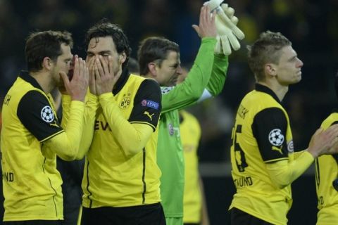 Dortmund players react after the UEFA Champions League quarter-final, second leg football match Borussia Dortmund vs Real Madrid CF on April 8, 2014 in Dortmund, western Germany.  AFP PHOTO / JOHANNES EISELE        (Photo credit should read JOHANNES EISELE/AFP/Getty Images)