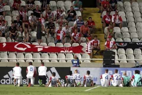 Players of Slavia Praha sit on the pitch in front of their fans at the end of a Champions League play offs first leg soccer match between Apoel Nicosia and Slavia Praha at GSP stadium in Nicosia, Cyprus, Tuesday, Aug. 15, 2017. (AP Photo/Philip Soteriou)