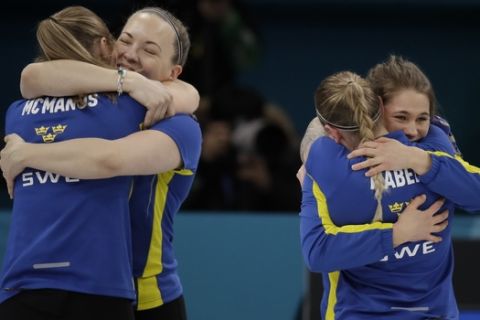 Sweden celebrates after winning the gold medal in their women's curling final in the Gangneung Curling Centre at the 2018 Winter Olympics in Gangneung, South Korea, Sunday, Feb. 25, 2018. (AP Photo/Aaron Favila)