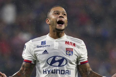 Lyon's Memphis Depay reacts after missing a chance to score during the French League 1 soccer match between Lyon and Paris SG, at the Stade de Lyon in Decines, outside Lyon, France, Sunday, Sept. 22, 2019. (AP Photo/Laurent Cipriani)