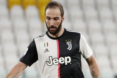 Juventus' Gonzalo Higuain controls the ball during the Serie A soccer match between Juventus and Sampdoria at the Allianz stadium, in Turin, Italy, Sunday, July 26, 2020. (AP Photo/Antonio Calanni)