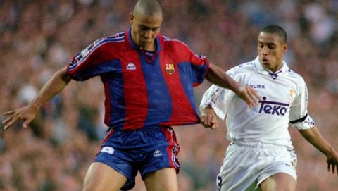 Barcelona's Brazilian star Ronaldo (left), gets his shirt pulled by fellow Brazilian Roberto Carlos of arch rivals Real Madrid during a top of the table league clash in Barcelona Saturday May 10, 1997. Ronaldo scored the only goal as Barcelona close the gap on Real Madrid. (AP Photo/Cesar Rangel)