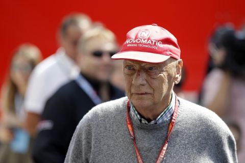 Former Formula One World Champion Niki Lauda of Austria walks in the paddock before the third free practice at the Silverstone racetrack, Silverstone, England, Saturday, July 7, 2018. The British Formula One Grand Prix will be held on Sunday. (AP Photo/Luca Bruno)