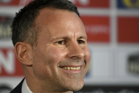 Wales manager Ryan Giggs smiles during a press conference at Hensol Caste, Vale Resort, Hensol, Wales, Monday, Jan. 15, 2018. Wales has handed Ryan Giggs his first coaching job since ending an illustrious playing career. The Football Association of Wales turned to its former winger, whose only previous experience as a manager was four games in temporary charge of Manchester United in 2014. (Ben Birchall/PA via AP)