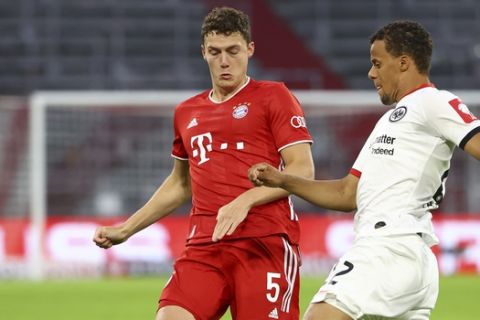 Eintracht Frankfurt's Timothy Chandler, right, in action with Bayern Munich's Benjamin Pavard during the German soccer cup semi-final match between Bayern Munich and Eintracht Frankfurt in Munich, Germany, Wednesday, June 10, 2020. (Kai Pfaffenbach/Pool via AP)
