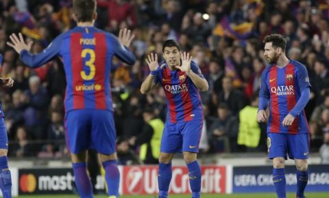 Barcelona's Luis Suarez center, gestures with his teammate Gerard Pique after scoring the opening goal during the Champion's League round of 16, second leg soccer match between FC Barcelona and Paris Saint Germain at the Camp Nou stadium in Barcelona, Spain, Wednesday March 8, 2017. At right is Barcelona's Lionel Messi. (AP Photo/Emilio Morenatti)